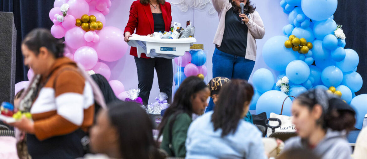 Susan Crutchfield, HPN, and Terrie Flaherty raffle off baby items during a community baby showe ...