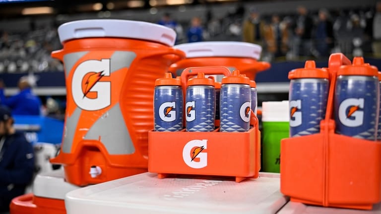 Gatorade bottles and coolers are seen on the sideline before...