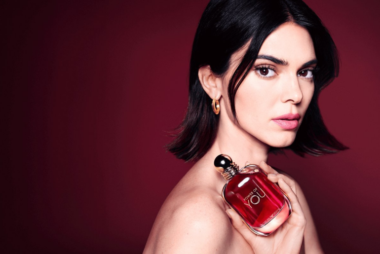 2026 loreal luxe brand armani kendall jenner holding a perfume bottle wearing golden hoops banner
