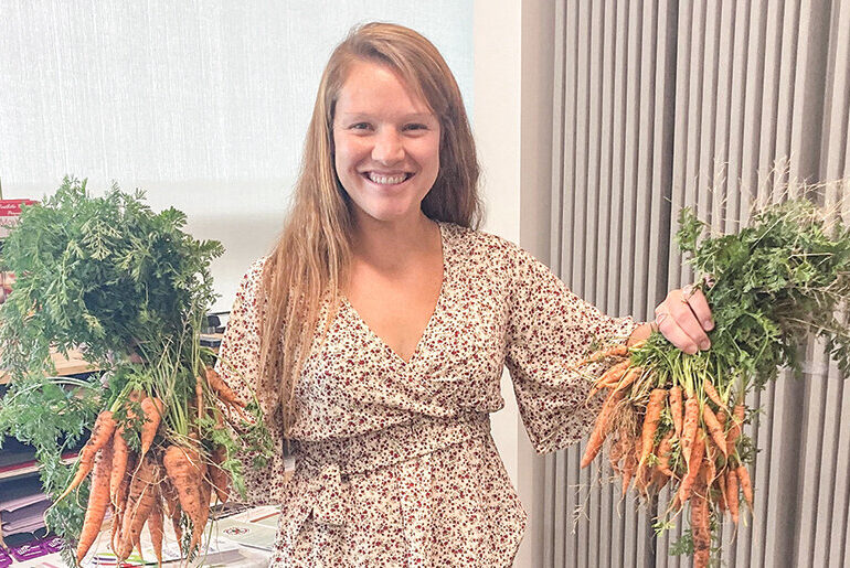 Kelsi Goldfarb, a CNP educator based in Laramie County, holds fresh carrots donated to a local hunger relief organization.