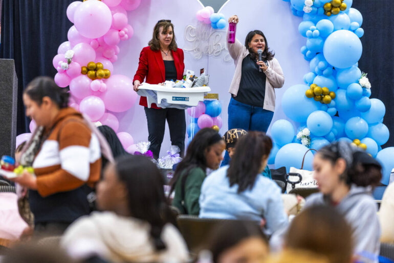 Susan Crutchfield, HPN, and Terrie Flaherty raffle off baby items during a community baby showe ...