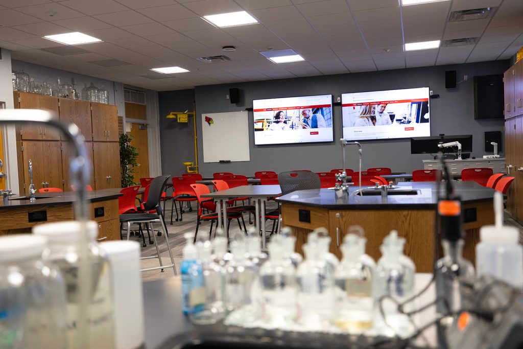 Lab with a sink and large screens.