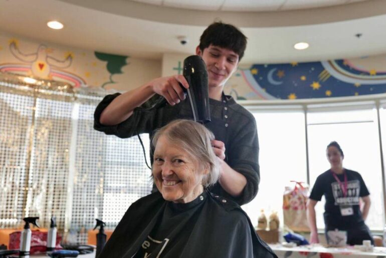 Maree shares a big smile as Latham of the Natural Hair Salon gives her a haircut during Our Place&rsquo;s Beauty Day. (Tony Trozzo/Victoria News)