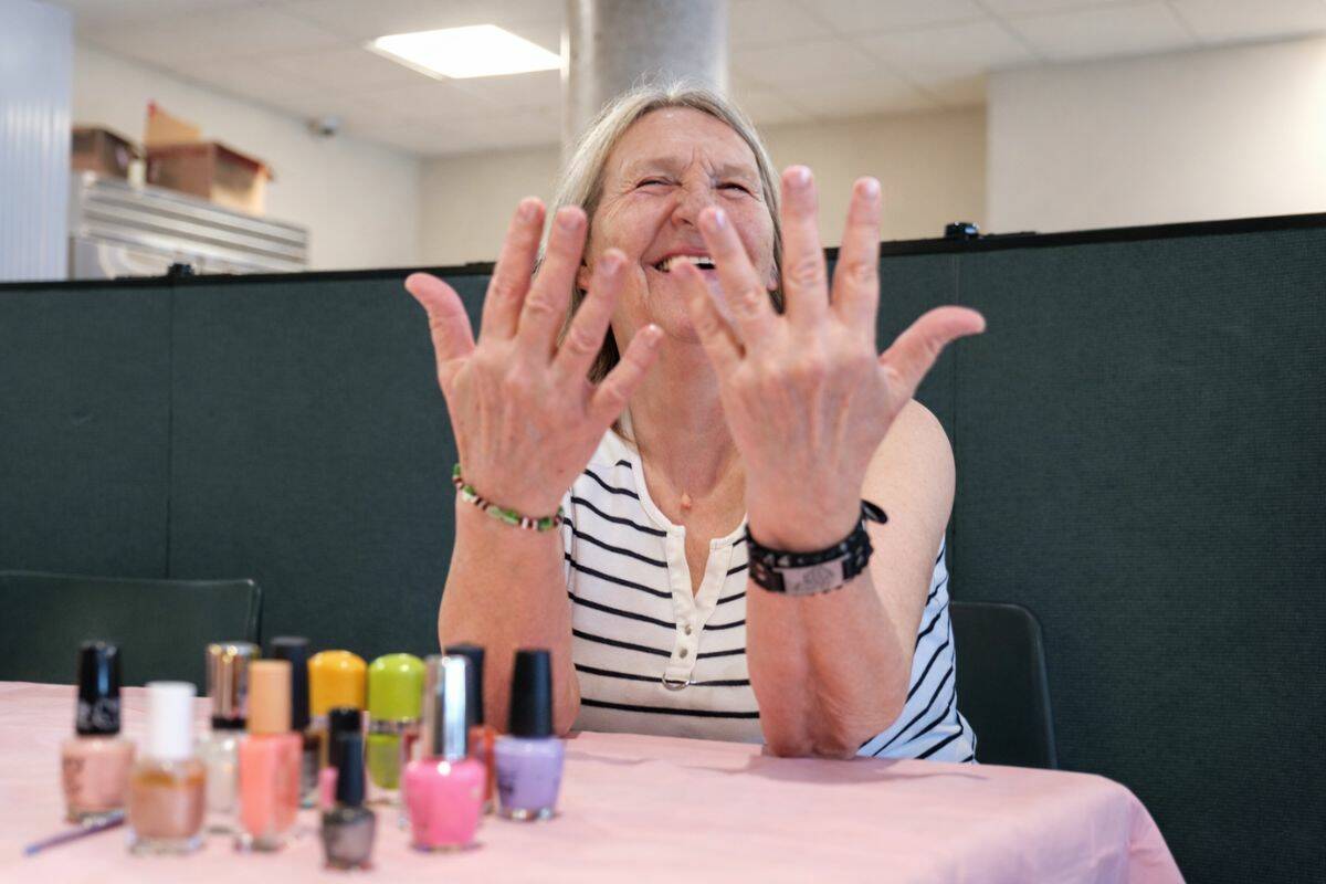 Val displays her nails following treatment during Beauty Day at Our Place. (Tony Trozzo/Victoria News)