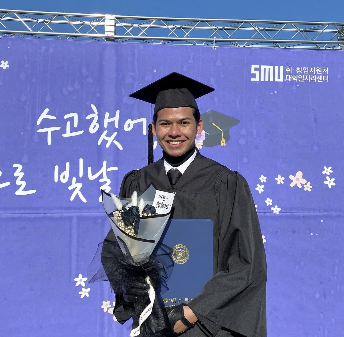 Muhammad Naufal Bin Omar poses for a photo with his graduation certificate at Semyung University in Jecheon, North Chungcheong. [MUHAMMAD NAUFAL BIN OMAR]