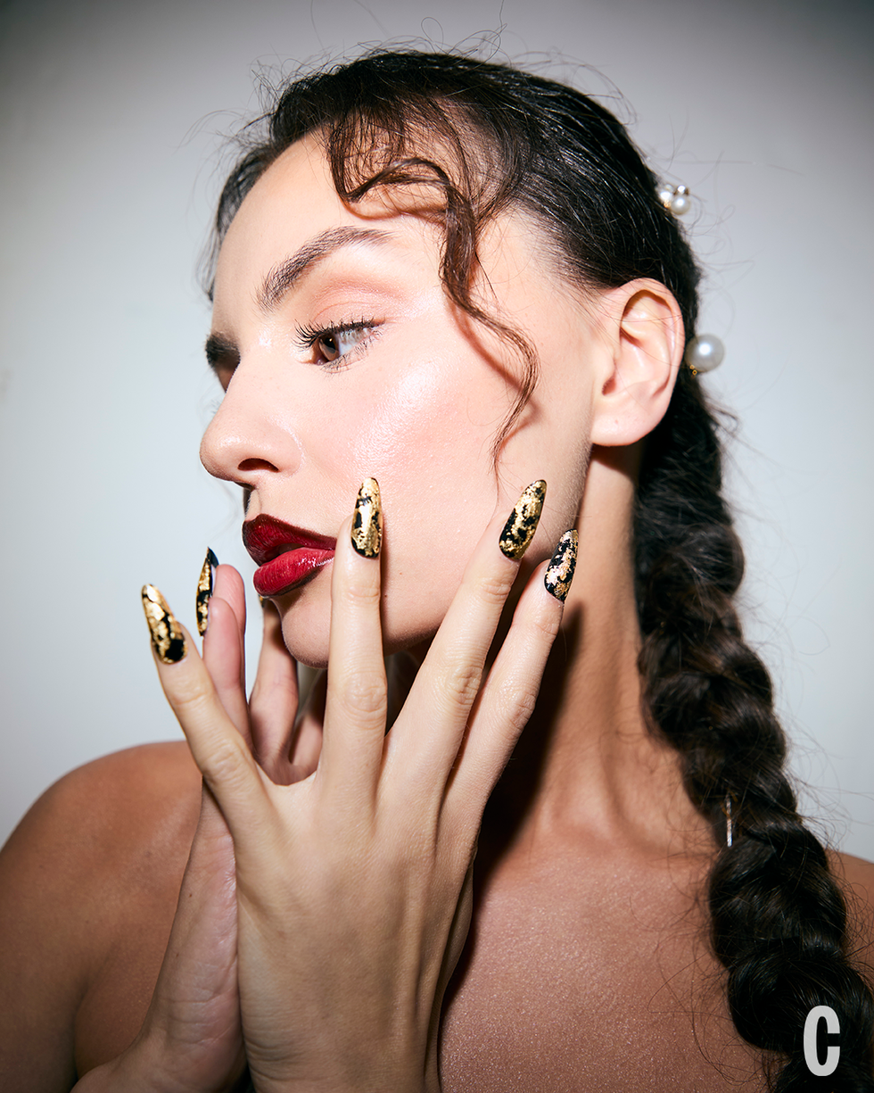 Close-up portrait featuring hands and hair.