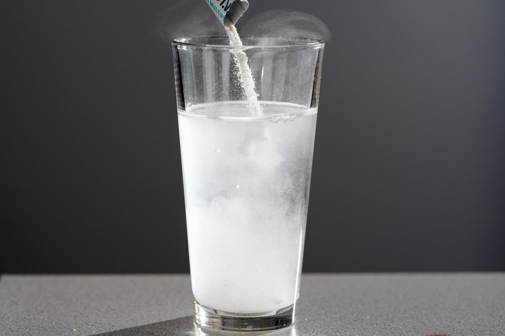 Electrolyte supplements are poured into glass of water Tuesday, Feb. 24, 2026, in Nashville, Tenn. (AP Photo/George Walker IV)