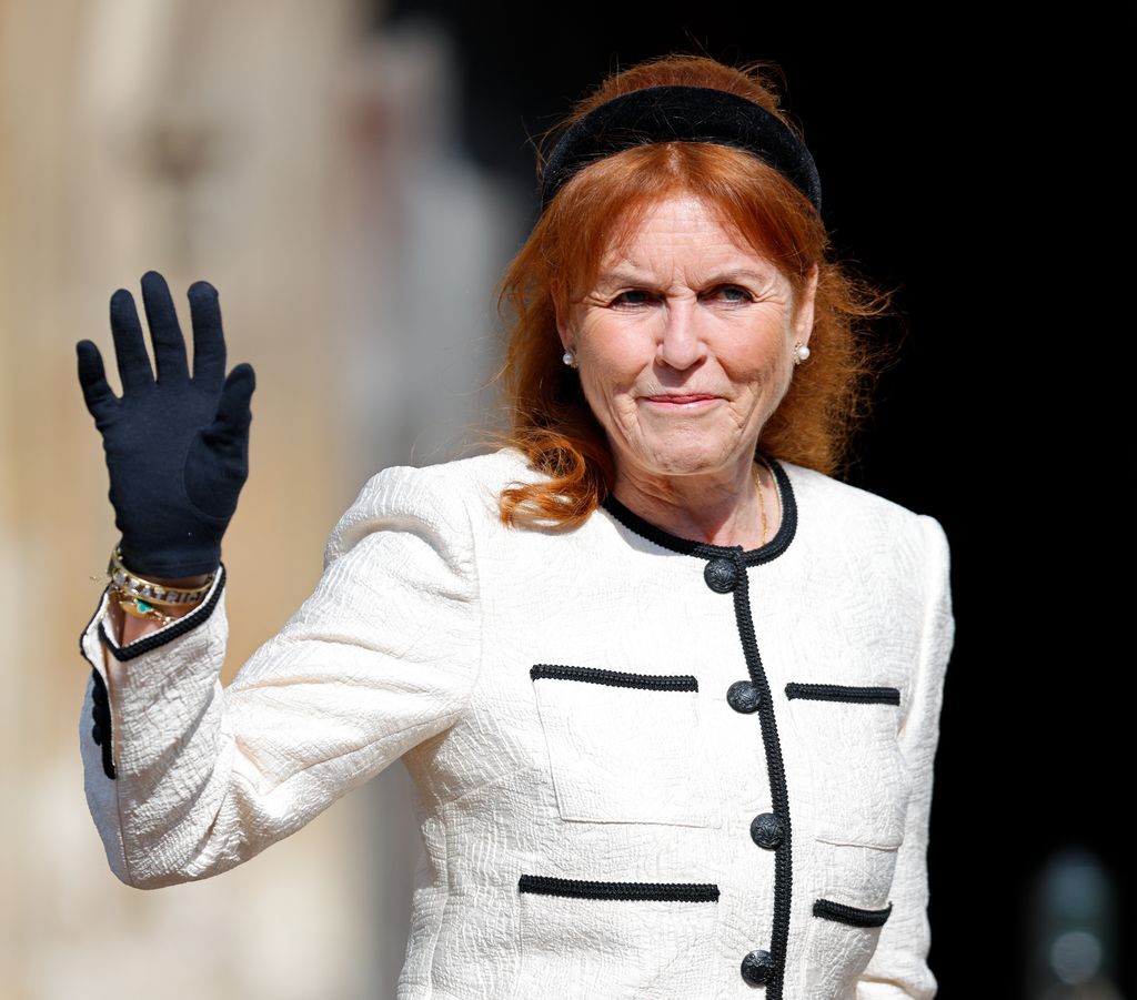 Sarah Ferguson waving in white and black blazer
