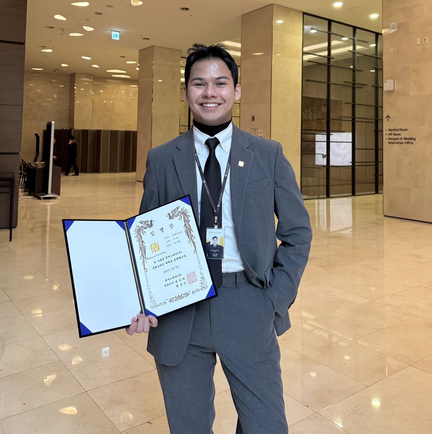 Muhammad Naufal Bin Omar poses for a photo with his promotion certificate after being elevated to head of Glutanex's content department. [MUHAMMAD NAUFAL BIN OMAR]