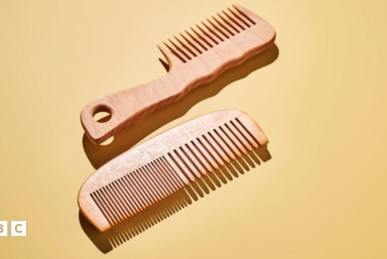 Two wooden combs on a yellow background