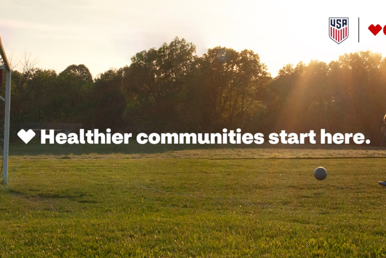 Child kicking a soccer ball towards a goal
