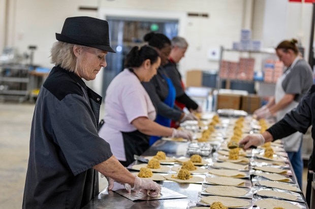 Konnie Weber works to roll breakfast burritos at Greeley-Evans School District's Central Production Kitchen in Greeley on Thursday, Feb. 5, 2026. (Brice Tucker/Staff Photographer)