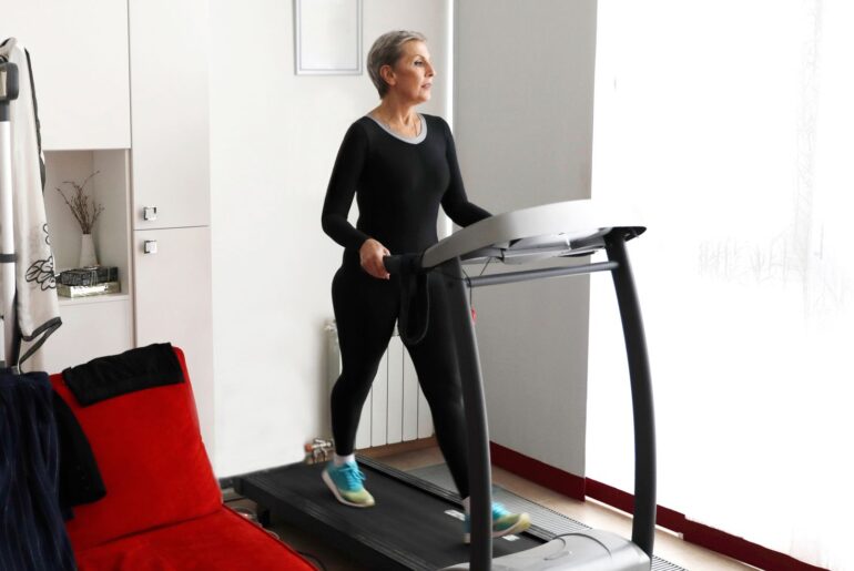 Woman walking on treadmill at home