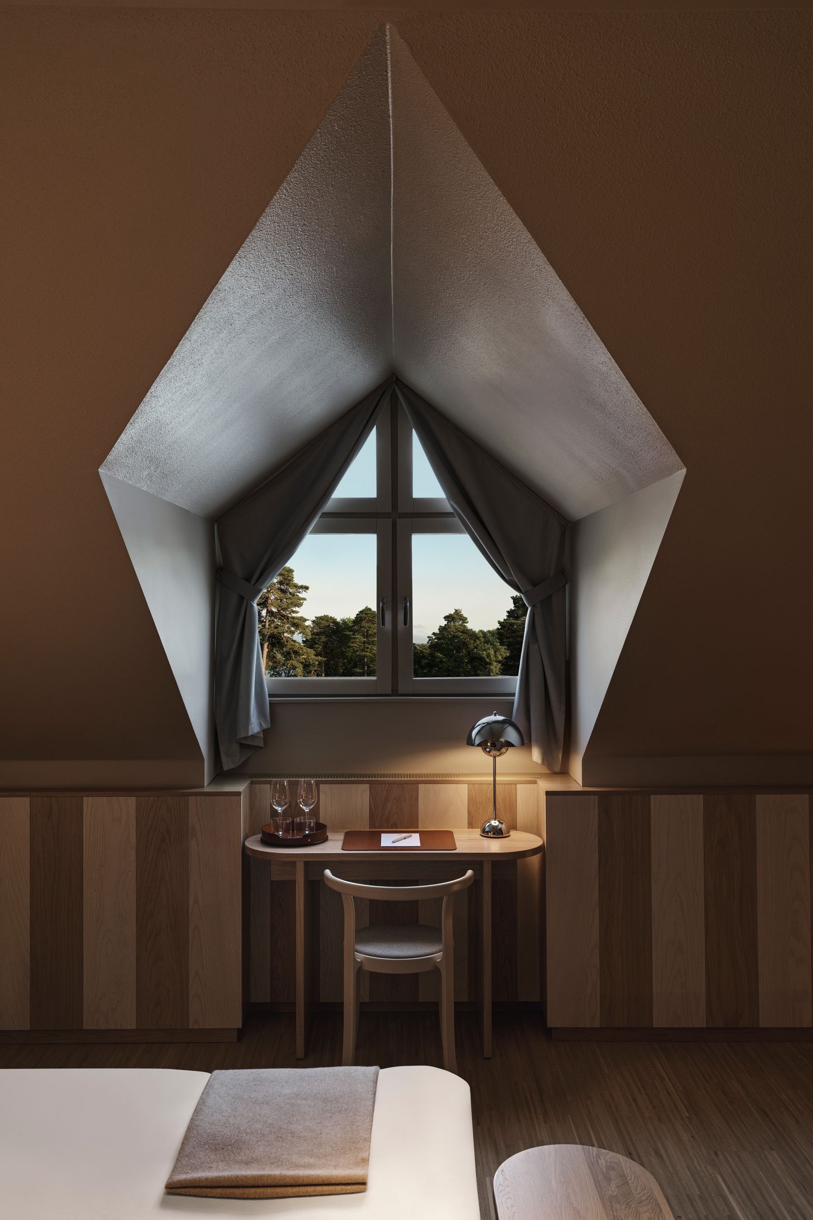 Image may contain Indoors Interior Design Chair Furniture Desk Table Lamp Window Architecture Building and House