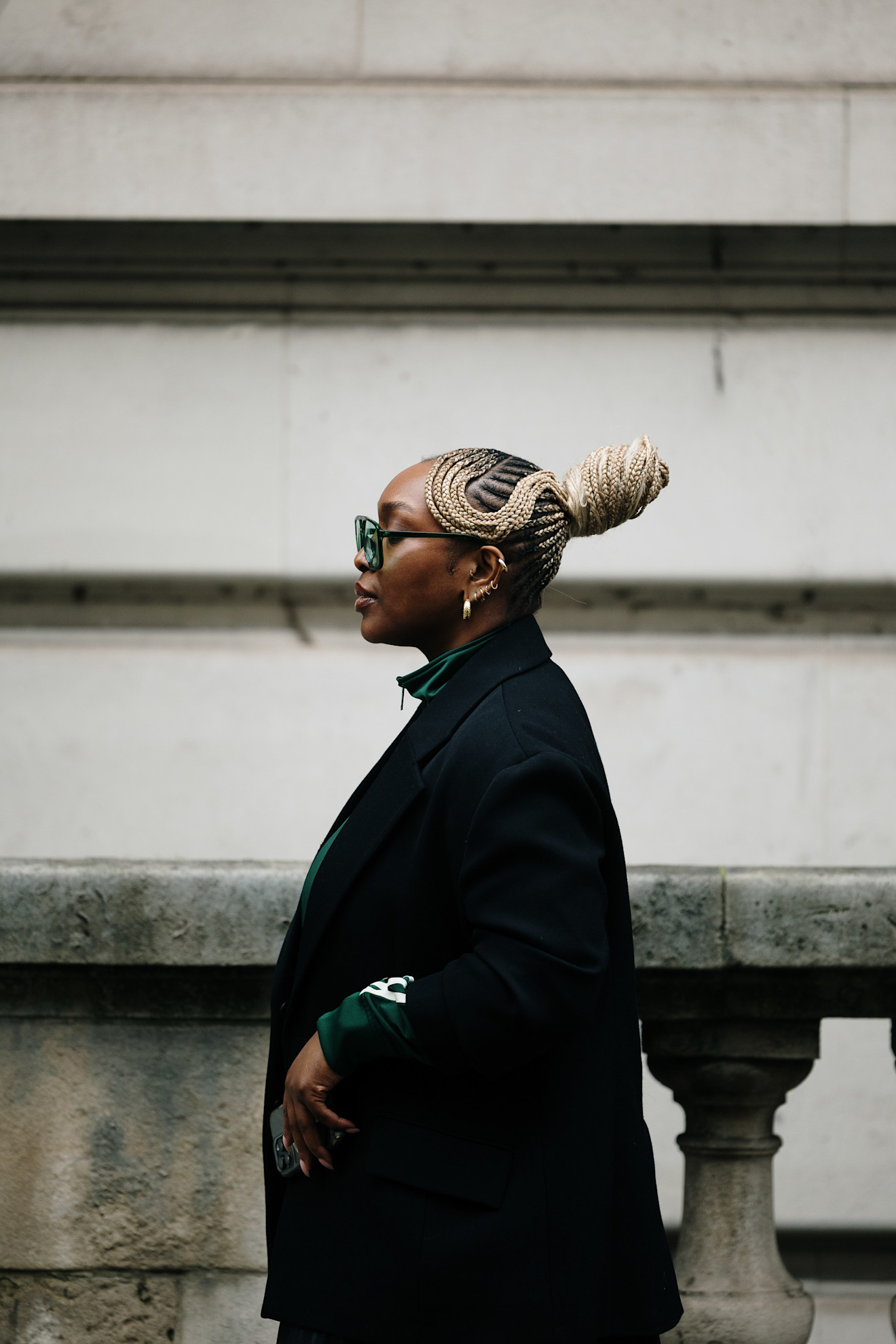 A woman with intricate blonde braids worn in an updo and tied into a bun