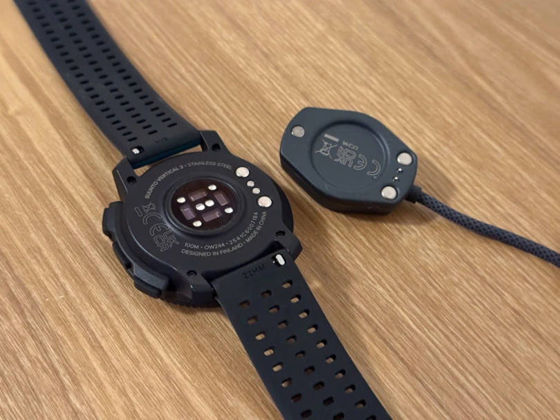 the backside of the vertical 2 watch, showing the heartrate sensor and charging cable