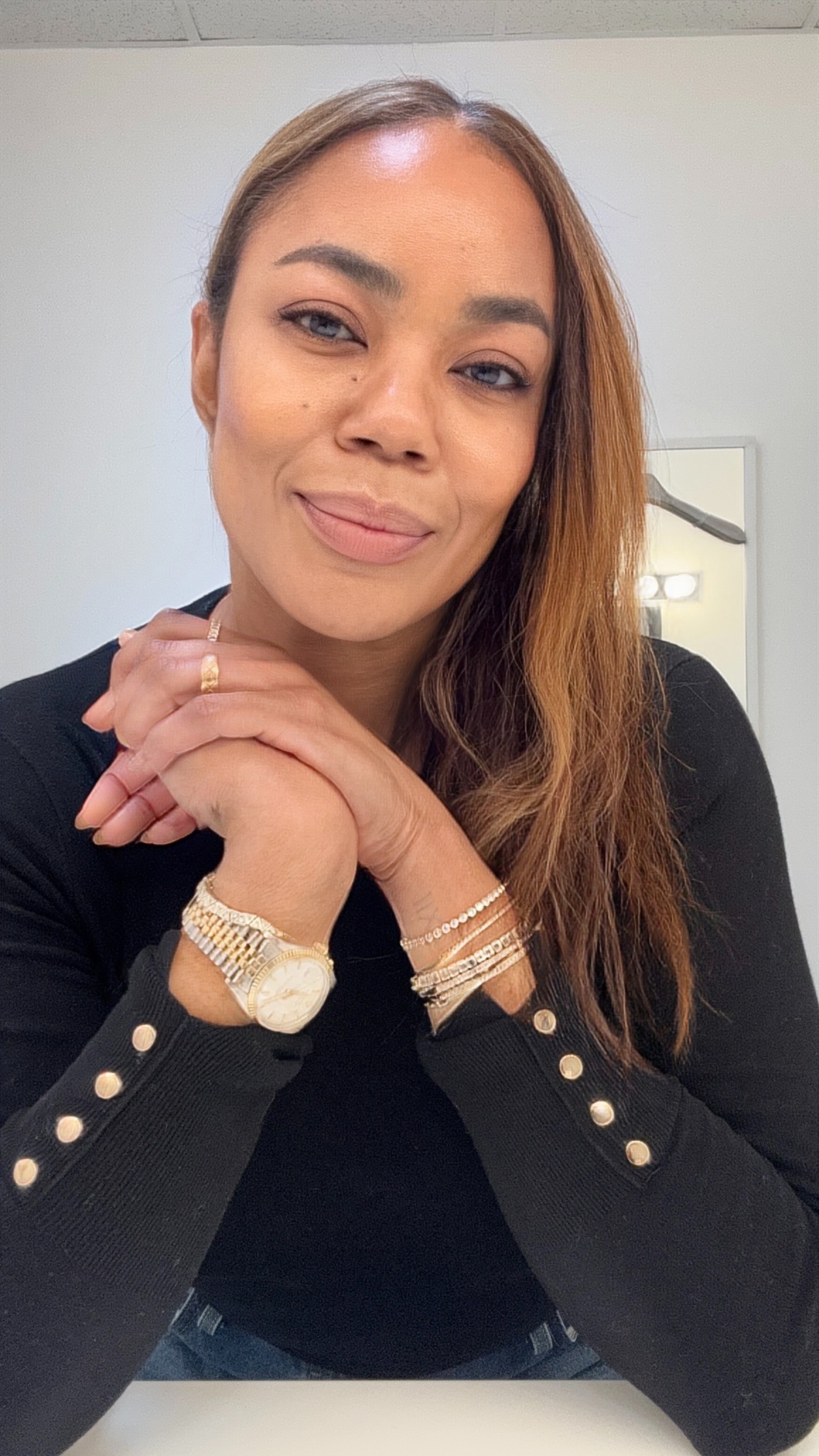 Tasha Reiko Brown wearing a bracelet stack.