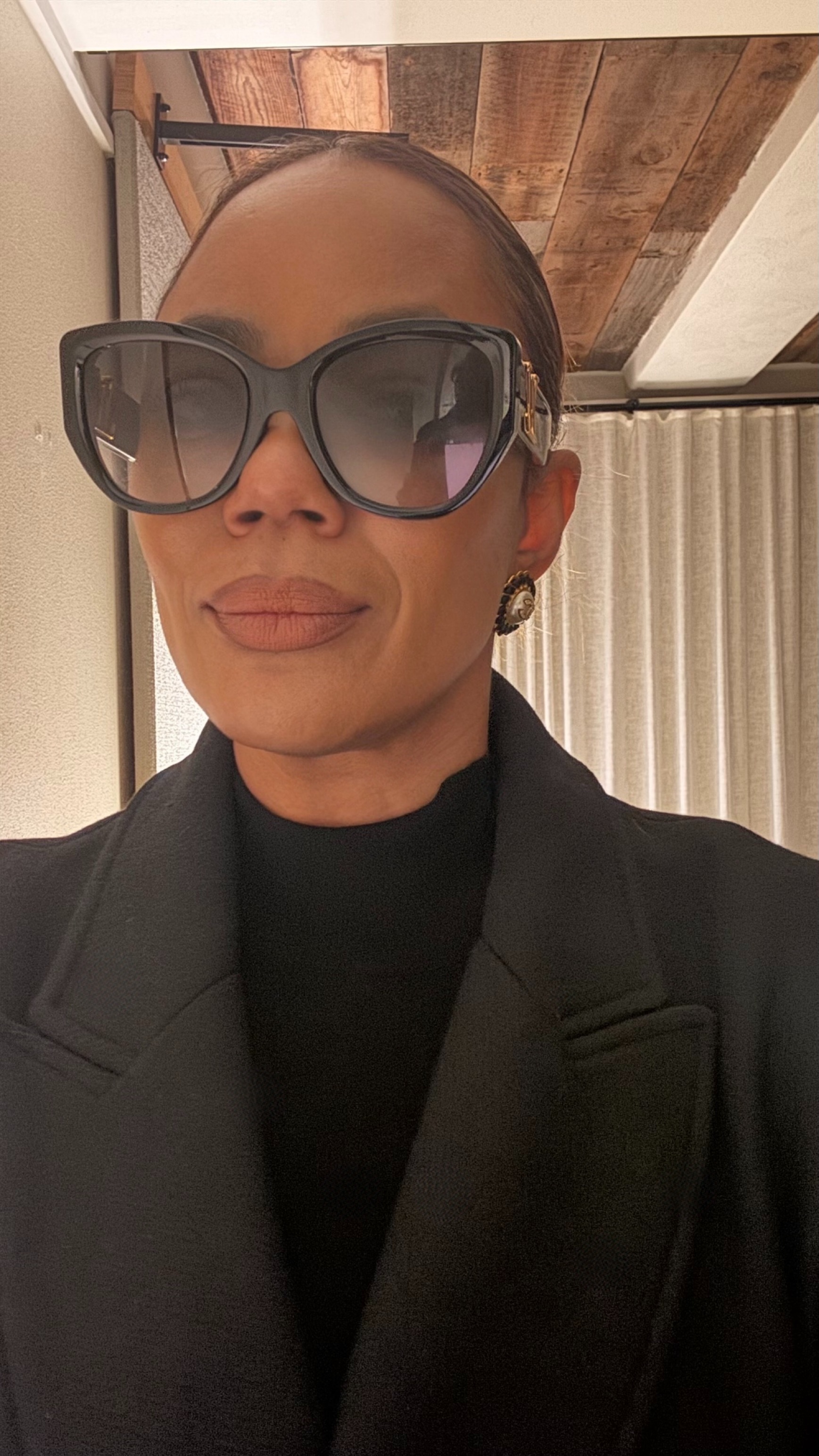 Tasha Reiko Brown wearing a black turtleneck and wool blazer.