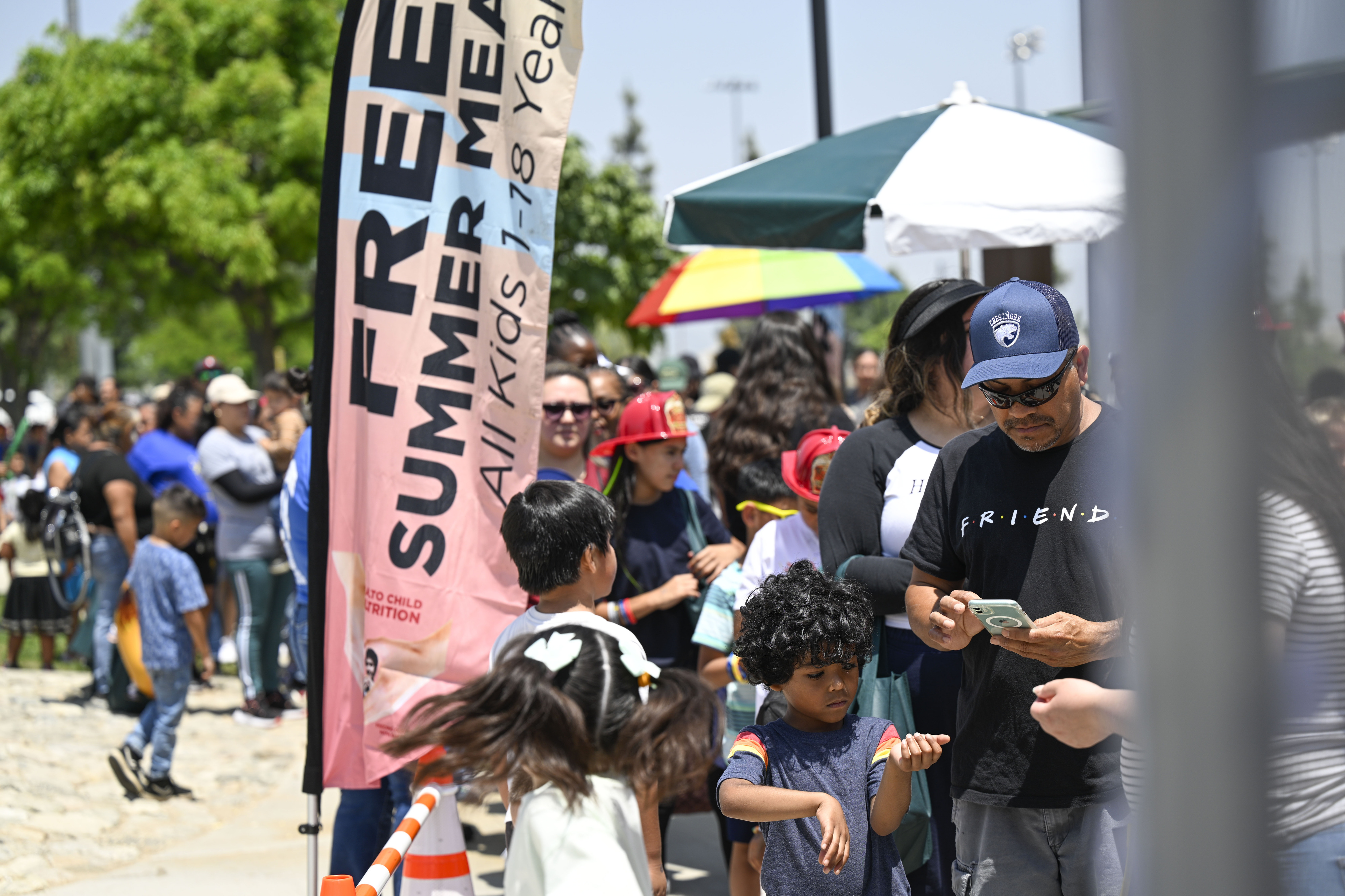 A line for free lunches forms Friday, June 7, 2024,...