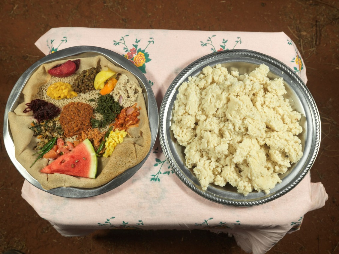 The plate on the left is a typical Ethiopian meal and the plate on the right is the ground Sorghum that Abdiya Edin, 35, cooks everyday called Boshe