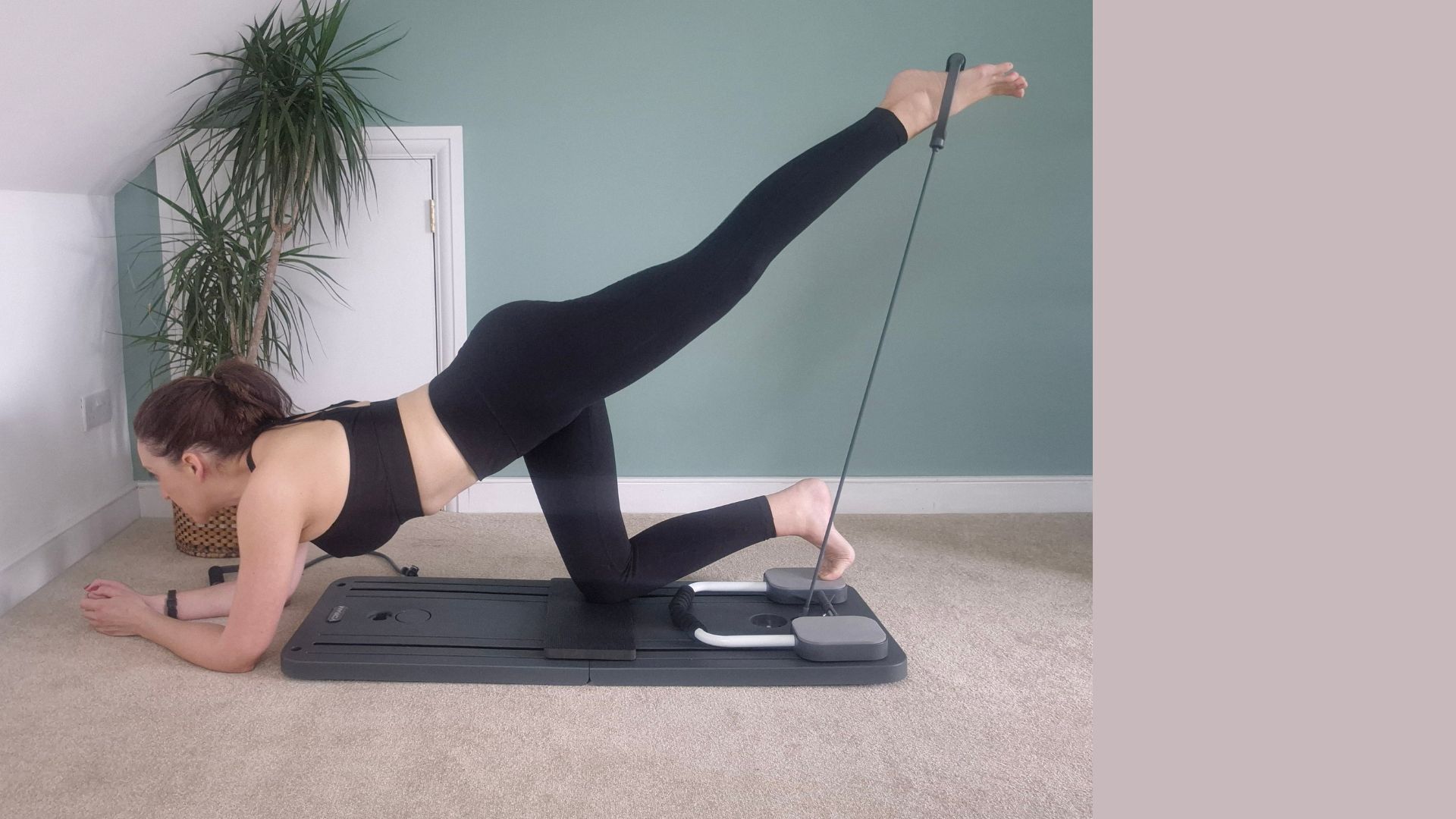 Kerry Law using Pilates board for leg exercises at home