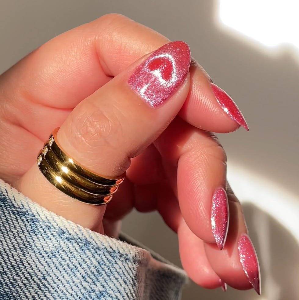 colorful manicured nails and rings on a hand colorful manicured nails and rings on a hand