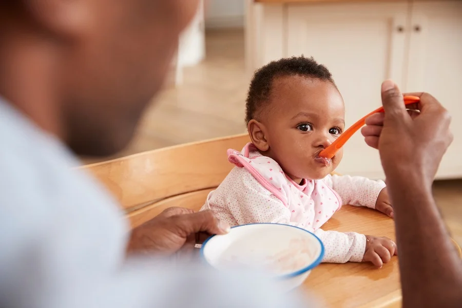Baby girl eating porridge