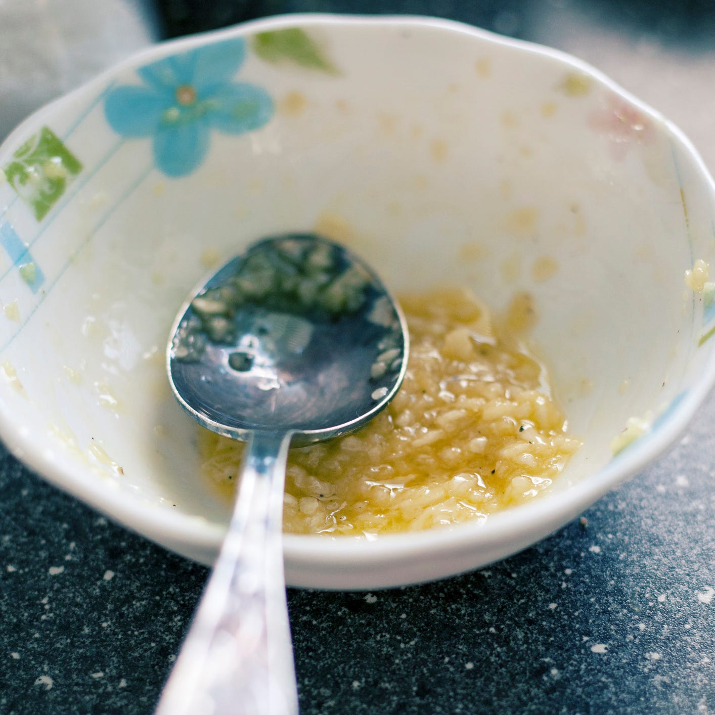 a bowl of minced garlic mixed with olive oil ready to be used as a spread on meat
