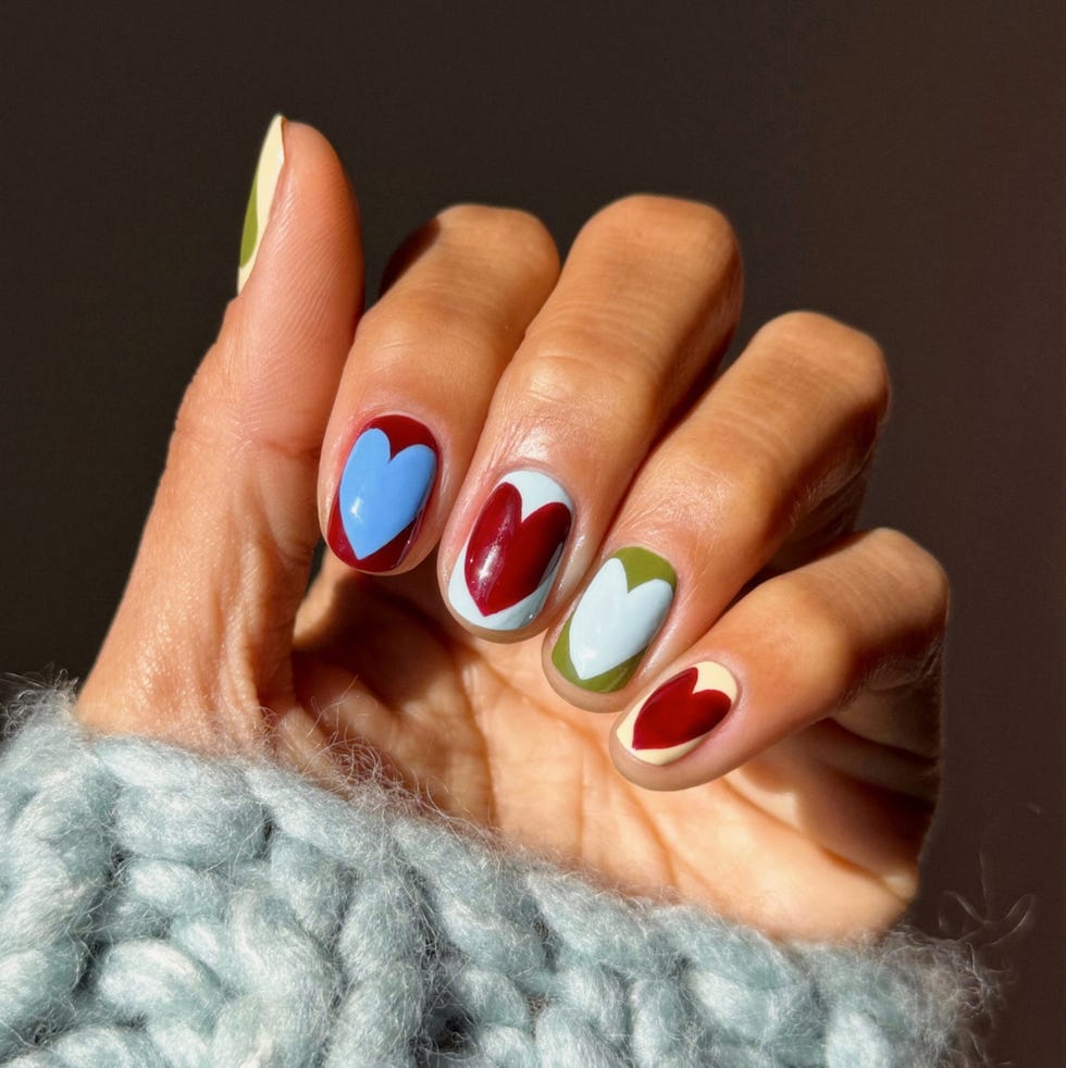 manicure featuring colorful heart designs on fingernails manicure featuring colorful heart designs on fingernails