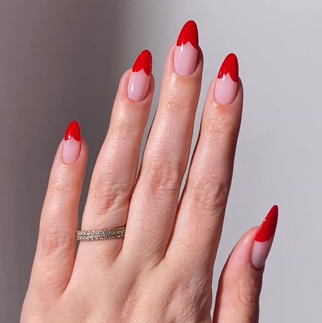 hand displaying stylish manicured nails with red tips hand displaying stylish manicured nails with red tips