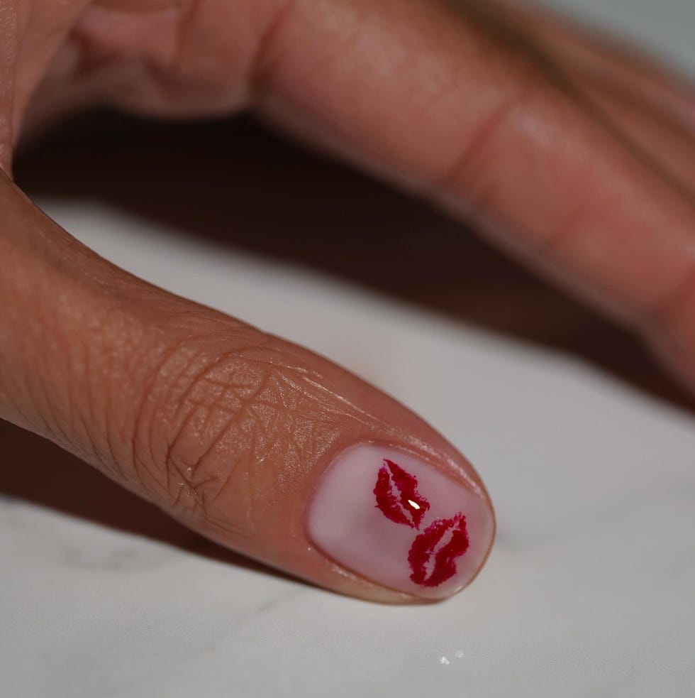 nail art featuring kiss marks on a fingertip nail art featuring kiss marks on a fingertip