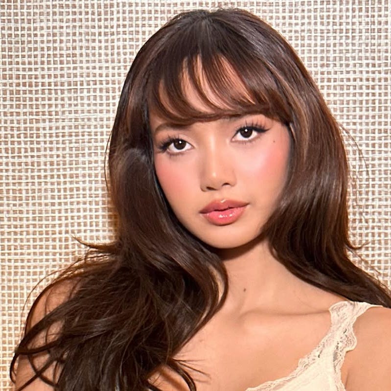 portrait featuring a person in a light tank top with long dark hair