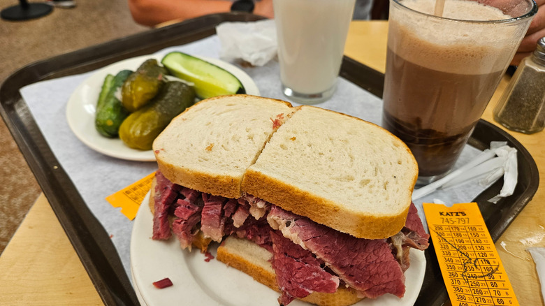 Pastrami sandwich, pickles, and two egg creams at Kat's delis