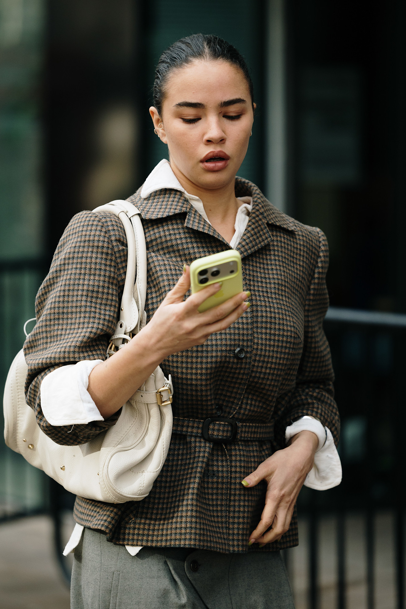A woman with a slicked-back bun and a berry stained lip look