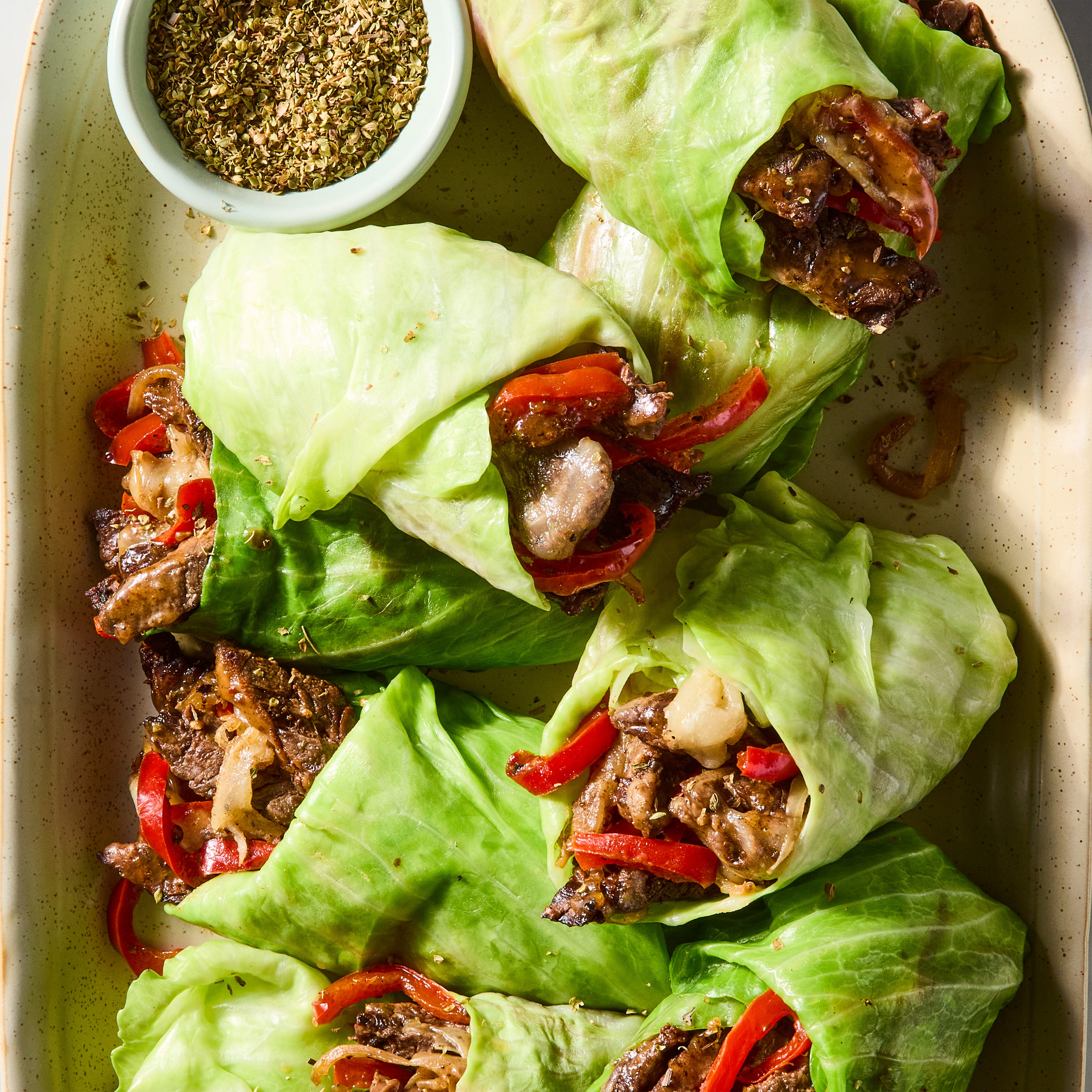 steak, peppers, and onions in a cabbage wrap