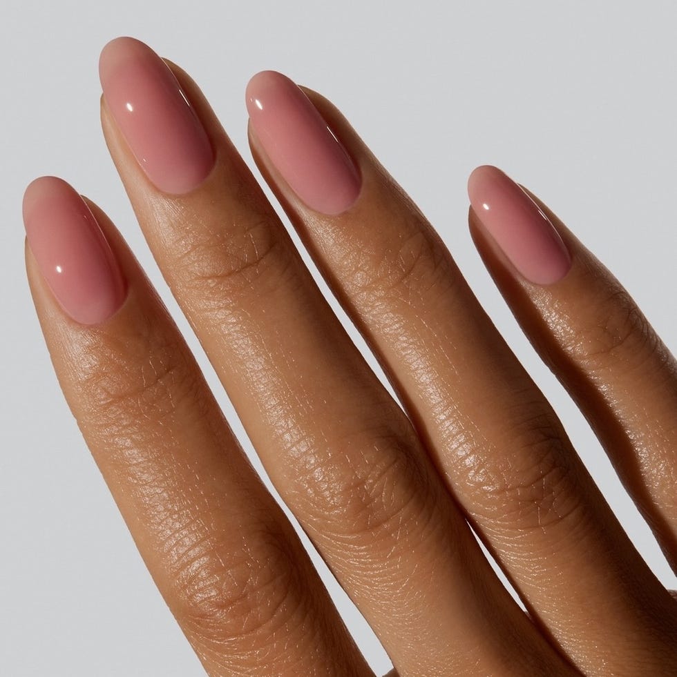 manicured nails coated with a glossy pink polish manicured nails coated with a glossy pink polish