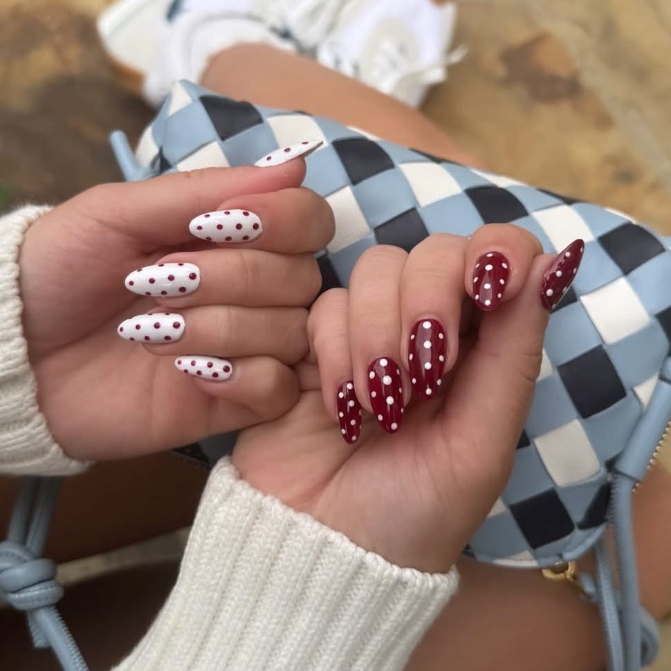 nail art featuring polka dots with a handbag in the background nail art featuring polka dots with a handbag in the background