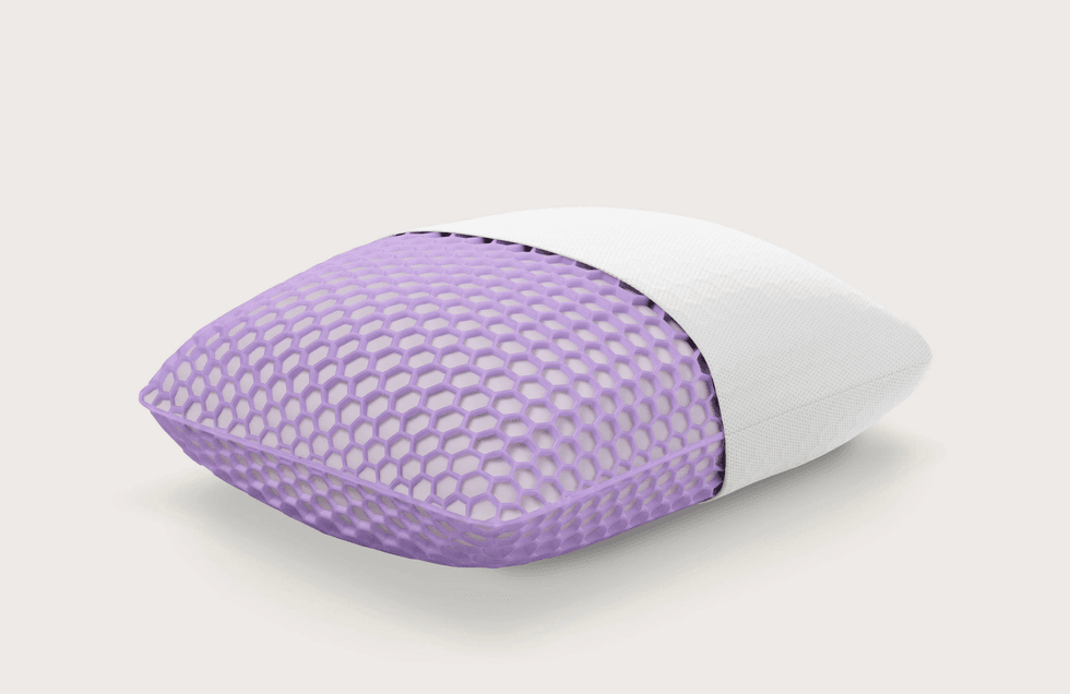 Purple hexagonal pillow with a white cover on a light background.