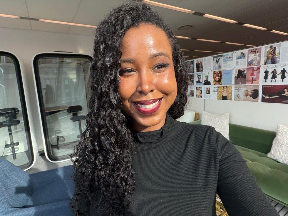 person in a black longsleeve shirt in a modern indoor setting