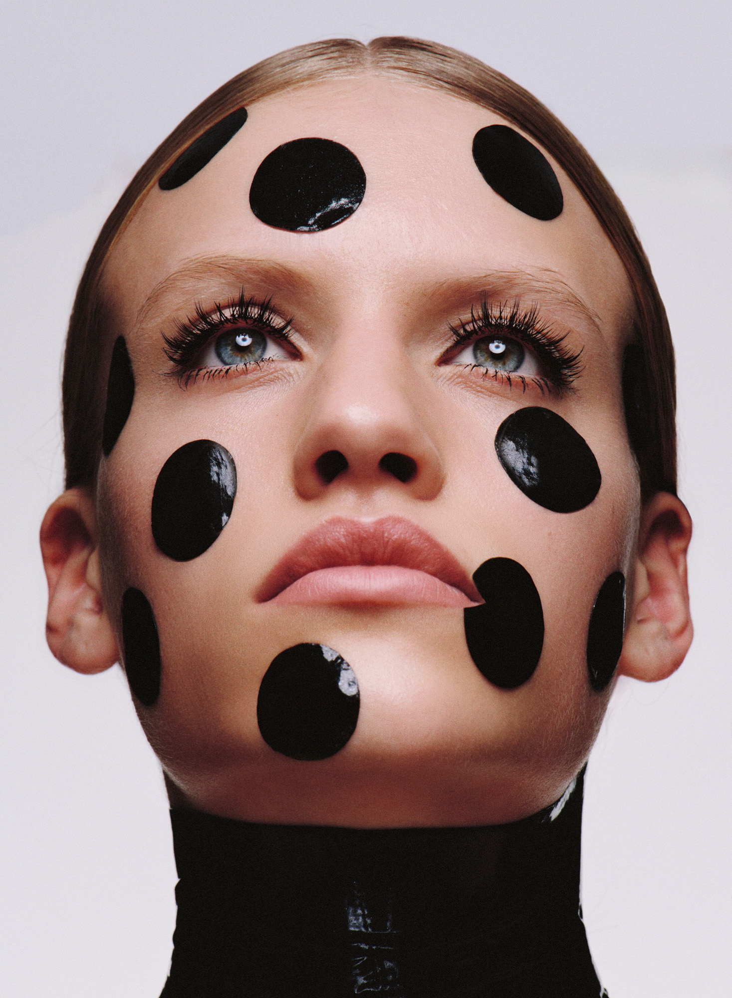 Woman with black dots of Skin111 face mask