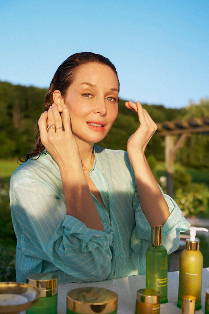 Tata Harper applies skincare.