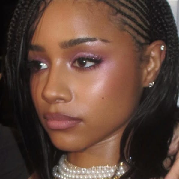 a person accessorizing with necklaces