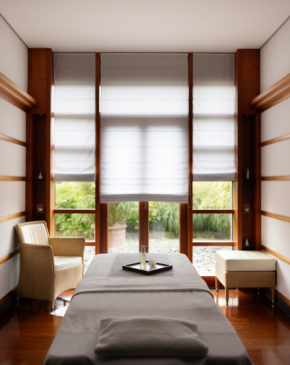 spa treatment room featuring a massage table and seating area