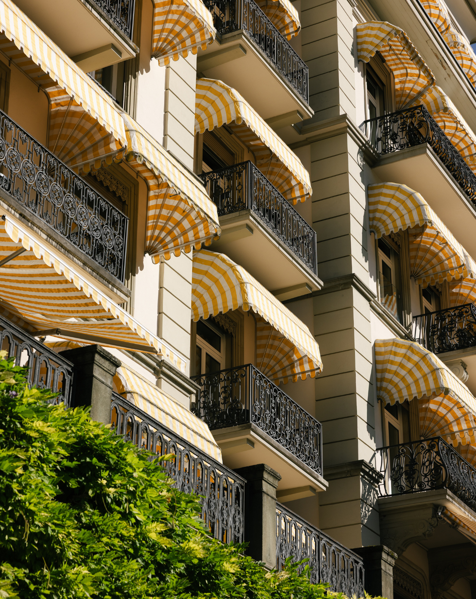 building facade with striped awnings and ornate balconies
