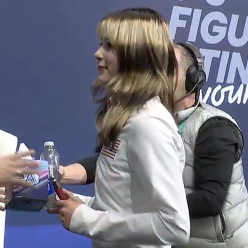 athlete receiving equipment in a competitive setting