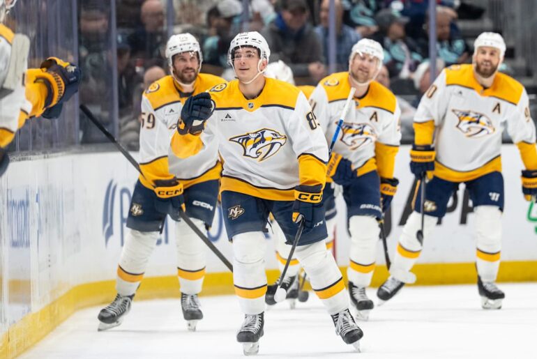 Mar 10, 2026; Seattle, Washington, USA; Nashville Predators defenseman Ryan Ufko (85), third from right, celebrates a goal during the second period against the Seattle Kraken at Climate Pledge Arena. Mandatory Credit: Stephen Brashear-Imagn Images