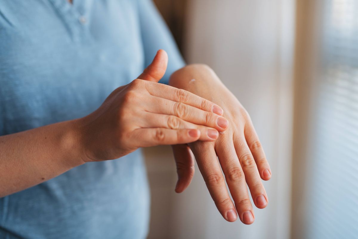 Close up of woman touching her hand