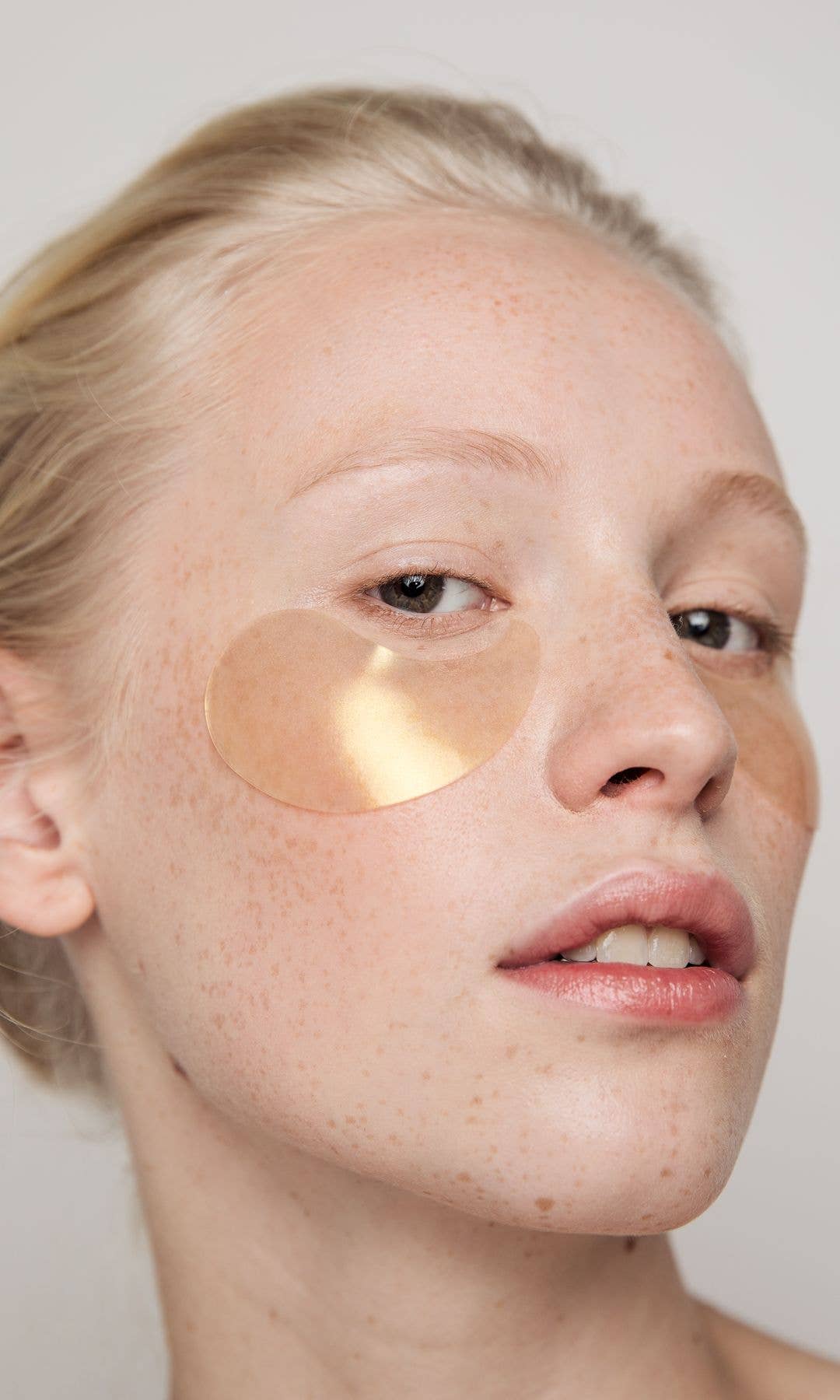 Model wearing an under-eye eye mask