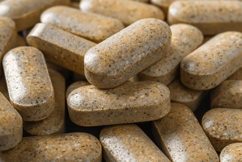 A close up photo of a pile of multivitamin supplements.
