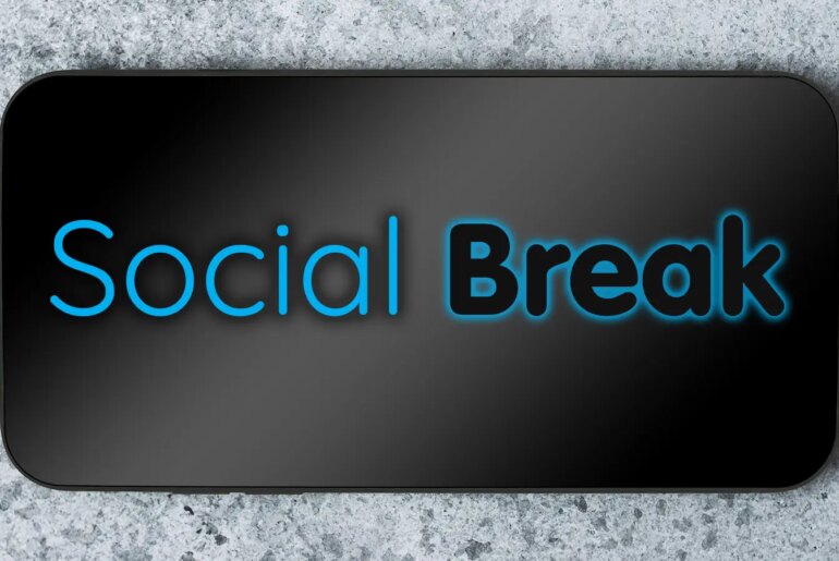 Social Break over a photo of a smartphone laying on a granite counter top